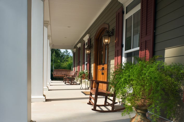 green-siding-red-shutters-porch-james-hardie