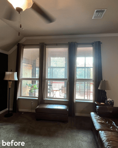 Three windows inside of a living room next to each other.