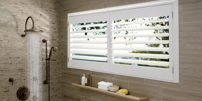 Hunter Douglas palm beach polysatin shutters in a bathroom shower in color bright white