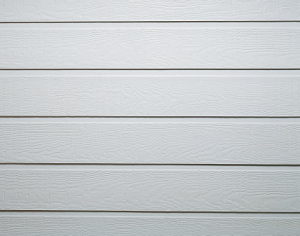 The image shows a close up shot of a white garage door with a wood-like texture.