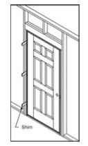 An illustration shows a door frame with a shim at the bottom labeled "Shim."