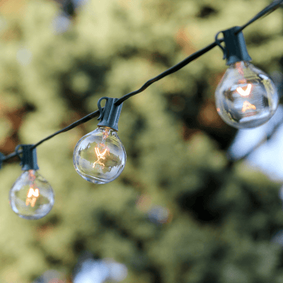 Circular bistro lights strung across a backyard.