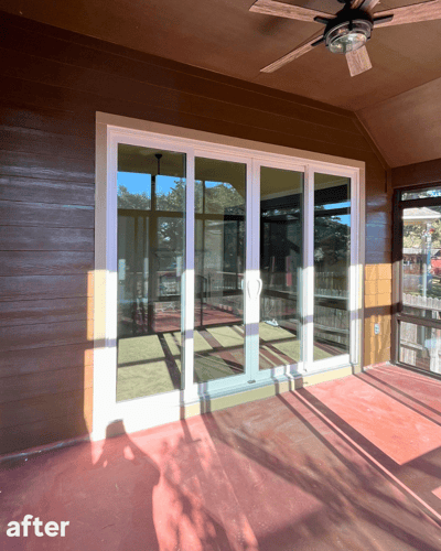 An after photo of a white sliding patio door in place of the three windows before.